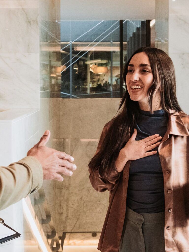 En glad kvinna pratar och skrattar med sina kollegor